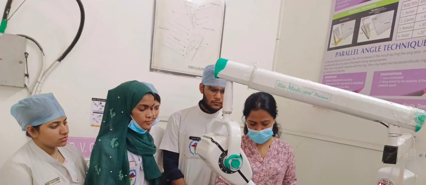 Dr. Shraddha Supnekar teaching intraoral radiographic technique on a phantom head to a group of students